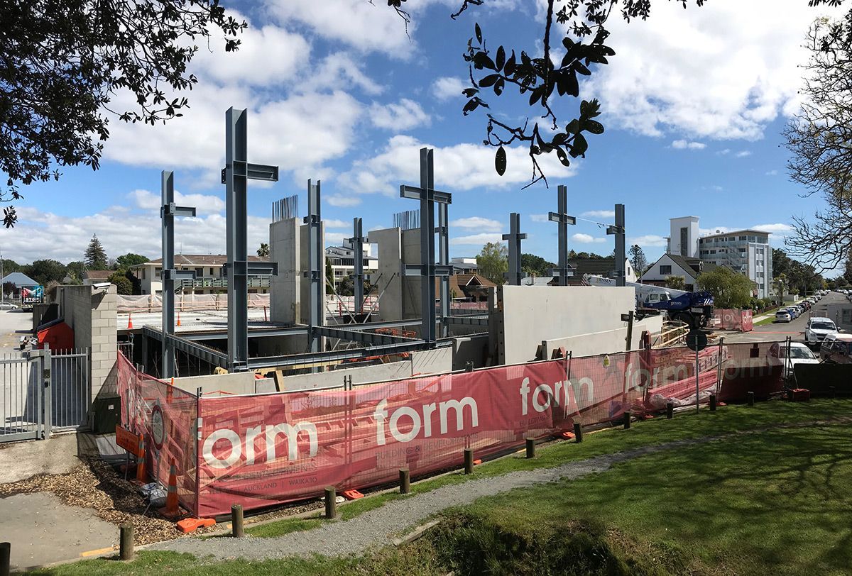 Construction site enclosed by orange fencing with 