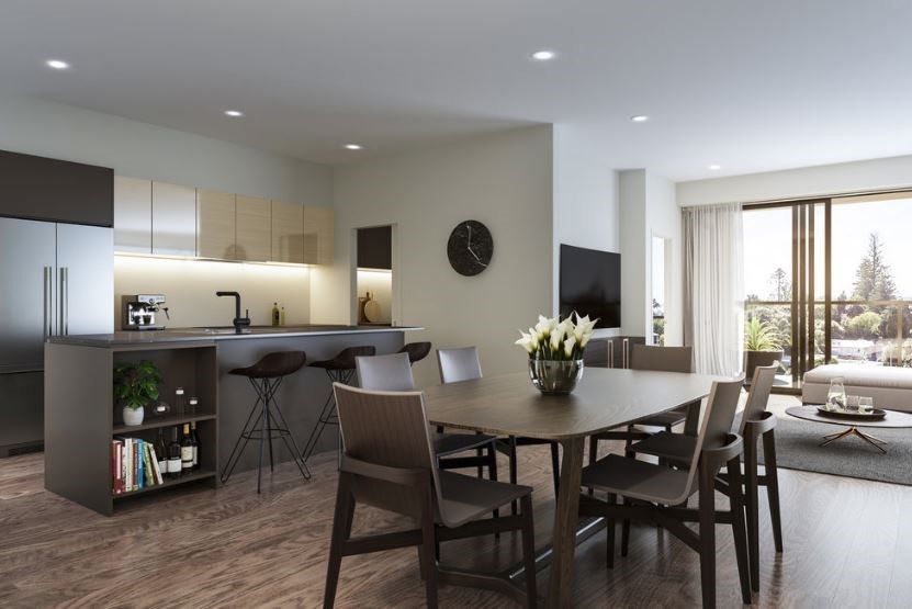 Modern open-concept kitchen and dining area. Features a dark island with bar stools, a dining table with chairs, and a view to a balcony.