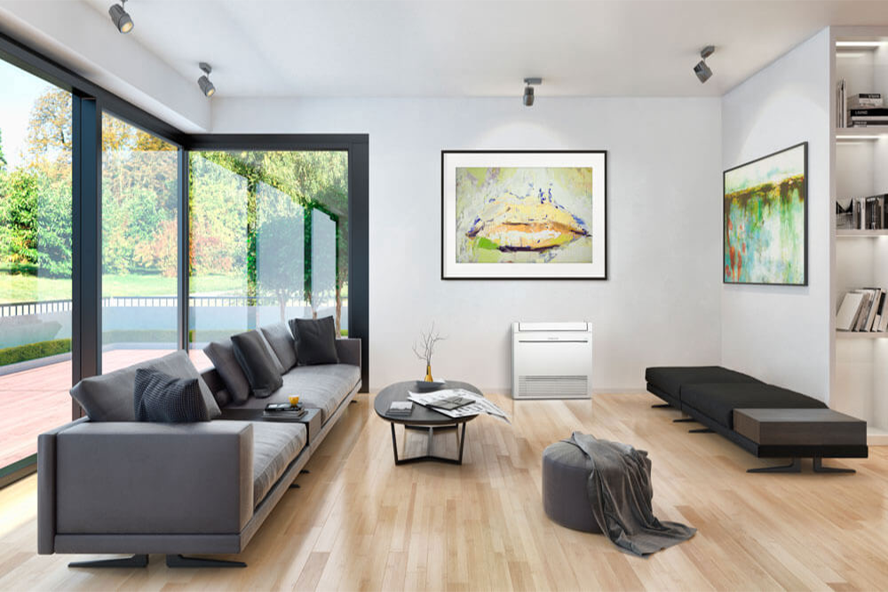 A living room with a couch , coffee table , and paintings on the wall.