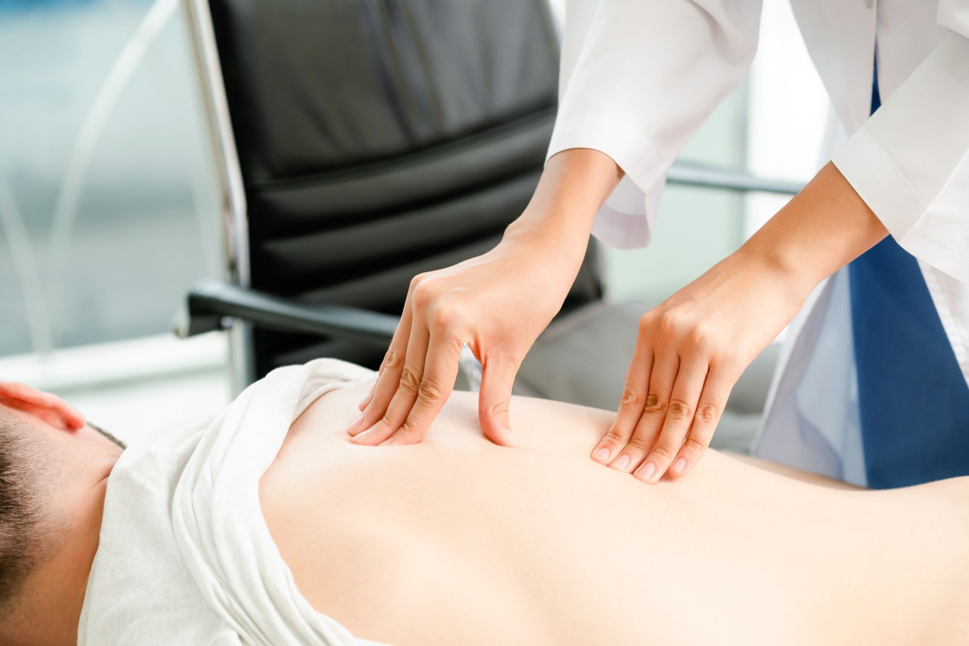 Man receiving a back massage in a doctor's office for back pain treatment in Philadelphia, PA.
