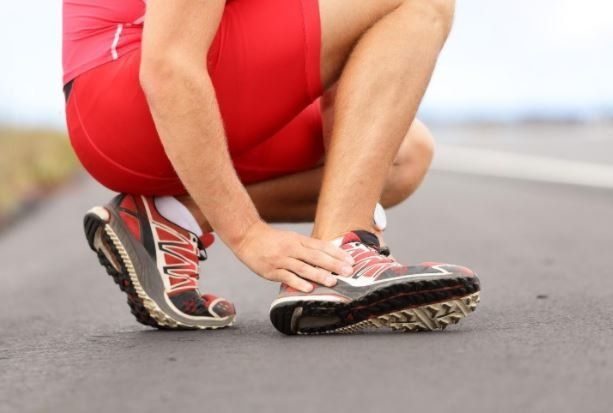 Runner Holding His Shoes — Philadelphia, PA — Advanced Physical Therapy