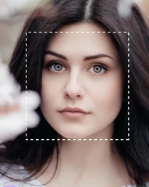 Woman with dark hair and gray eyes, soft focus.