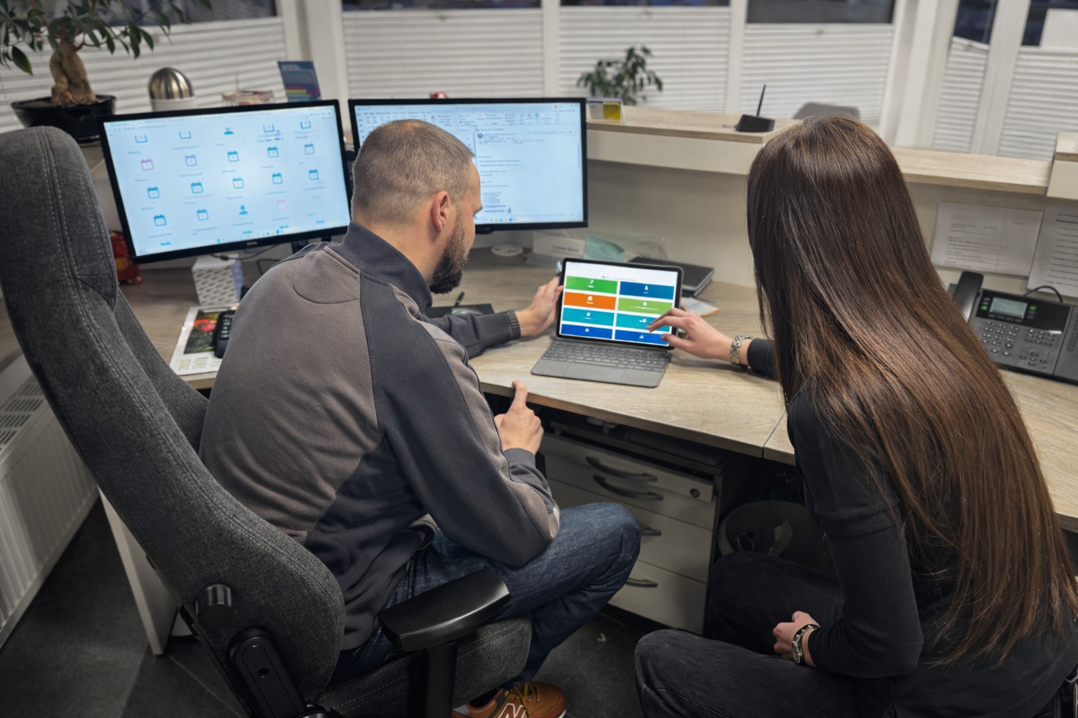 Mitarbeitende im Büro des Albers Lackierzentrums bei der gemeinsamen Arbeitsvorbereitung und Koordin