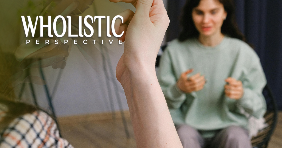 A person in a light green sweatshirt gestures during a conversation, with the text 