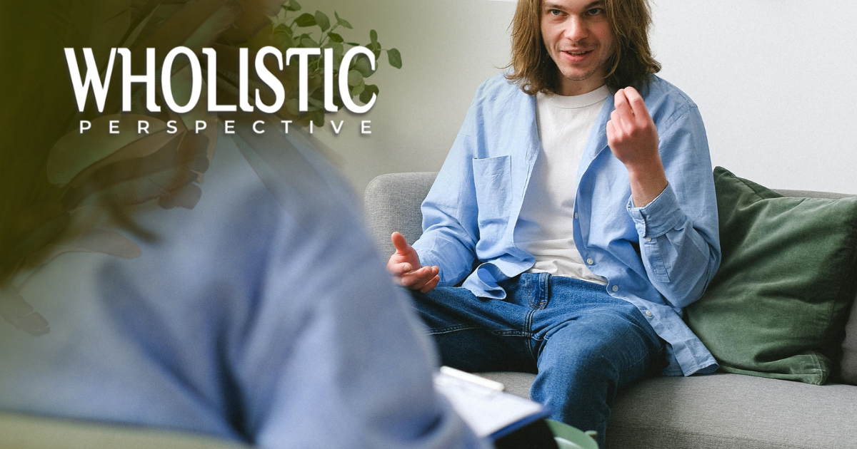 A person sits on a sofa, gesturing while speaking to another person who is taking notes. 