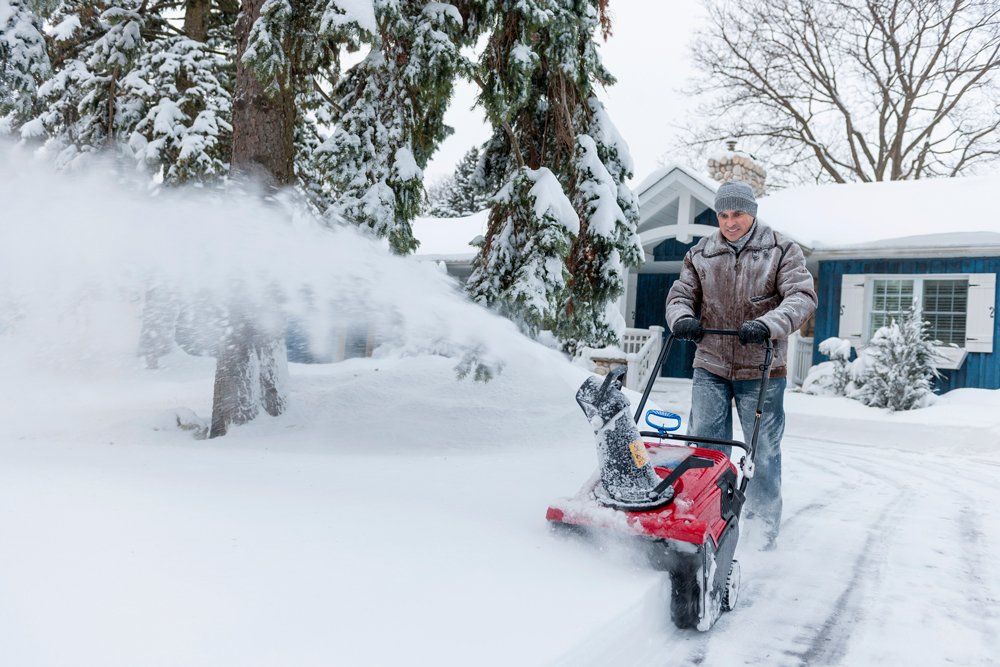 Another View Of A Gardener Removing Snow In The Yard — Coal Valley, IL — Kymbyl Komplete Kare , INC.