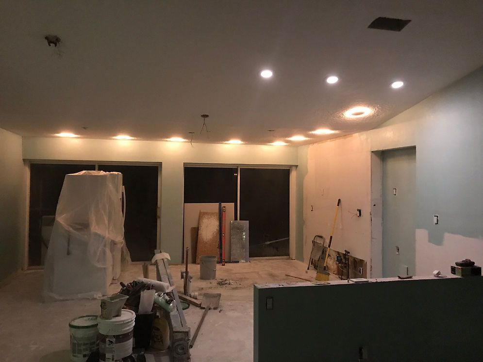 A room that is being remodeled with a lot of lights on the ceiling.