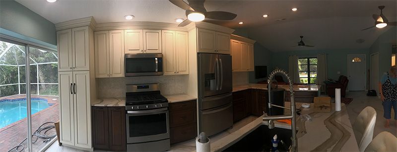 Kitchen with cabinets, appliances, and a view of a pool.