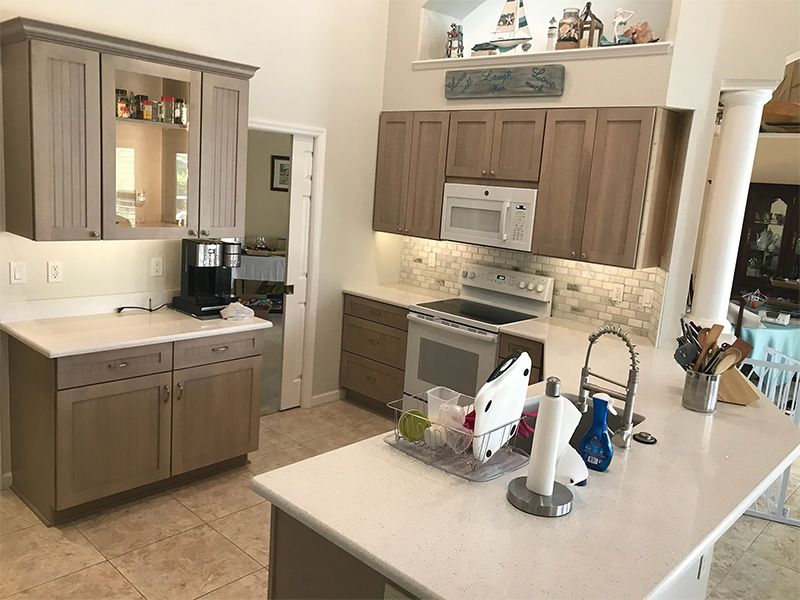 Kitchen with light-colored cabinetry, stainless steel appliances, and a large island.