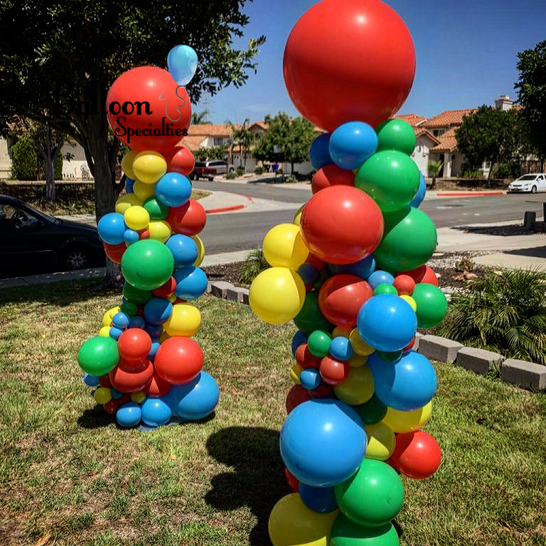 A bunch of colorful balloons are stacked on top of each other