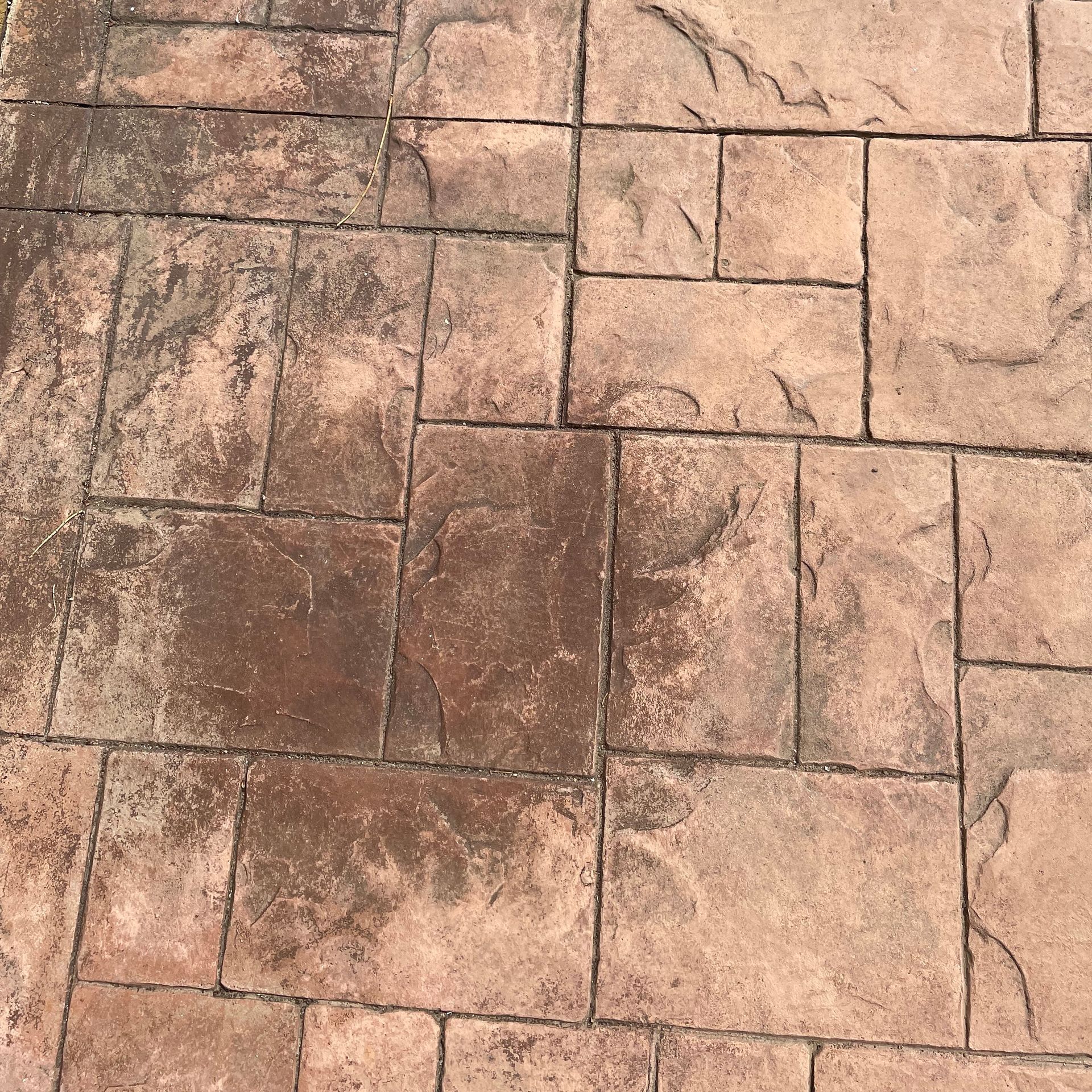 A close up of a brick floor with a pattern
