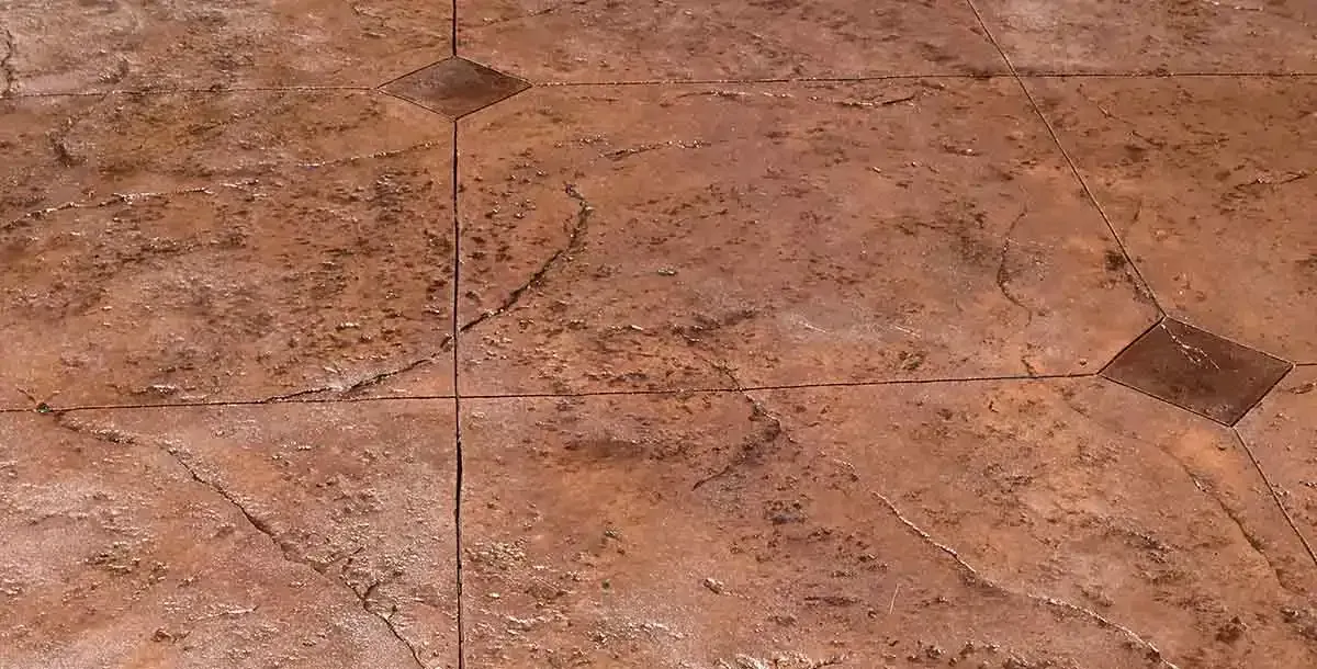 A close up of a brown tile floor with a geometric pattern.