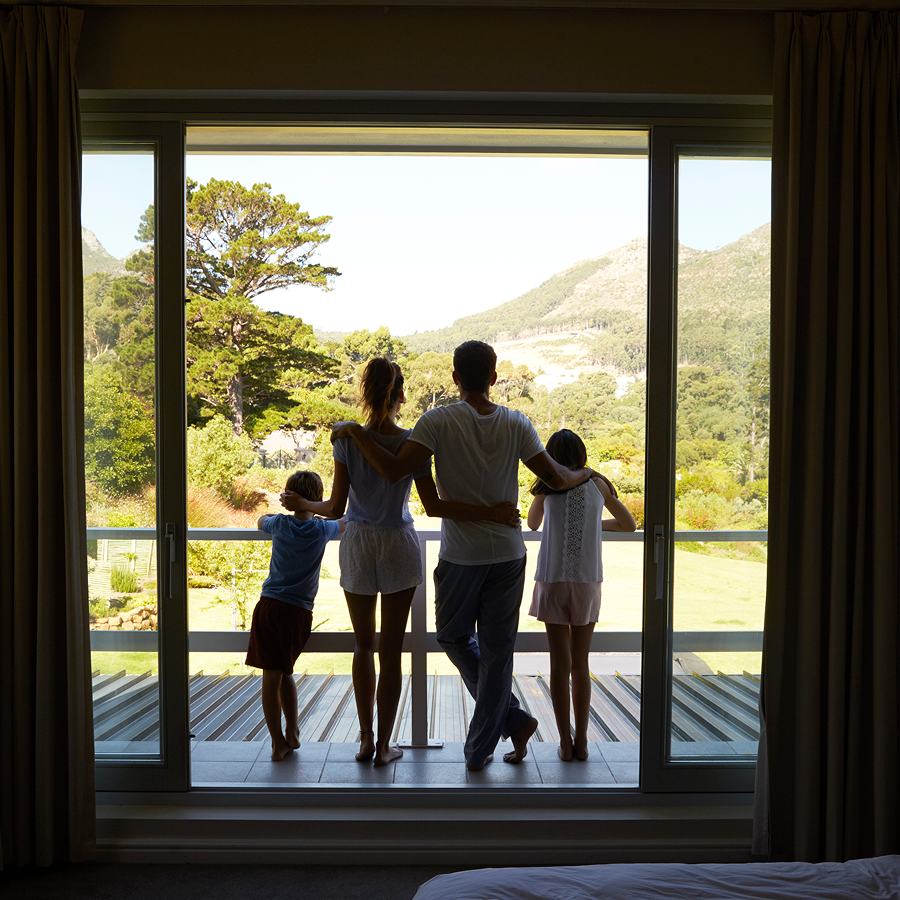 A family looking out of a sliding glass door