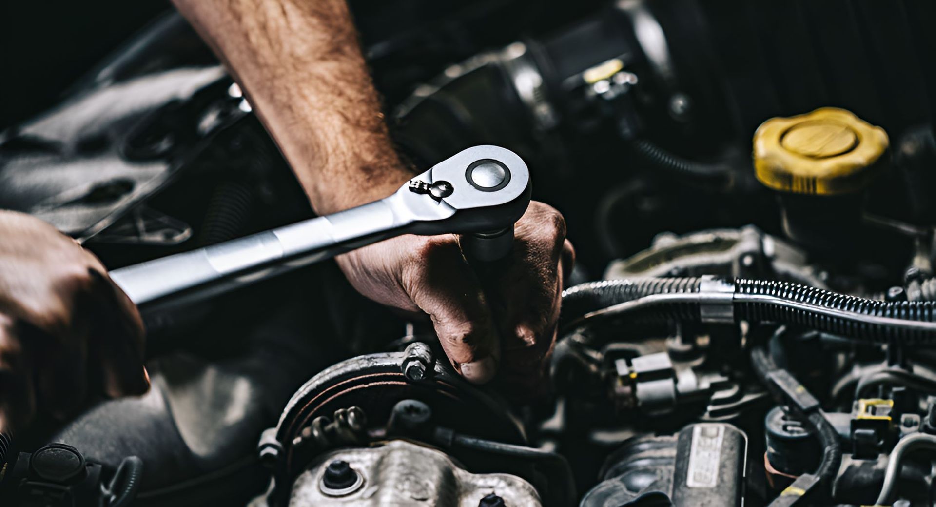 A Man Is Working On A Car Engine — All Models Service Centre In Wauchope, NSW