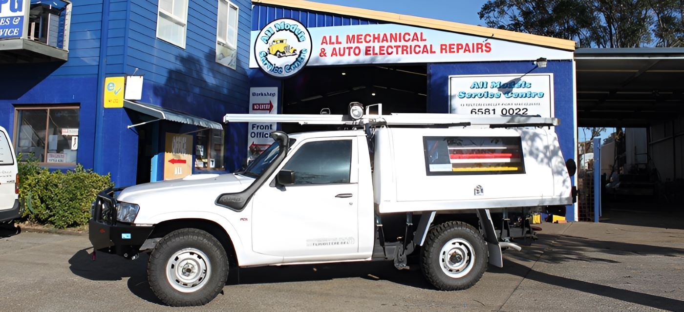 A White Truck Is Parked In Front Of A Building — All Models Service Centre In Port Macquarie, NSW