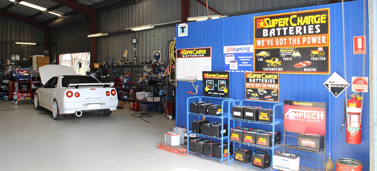 A White Car Is Parked In A Garage — All Models Service Centre In Port Macquarie, NSW