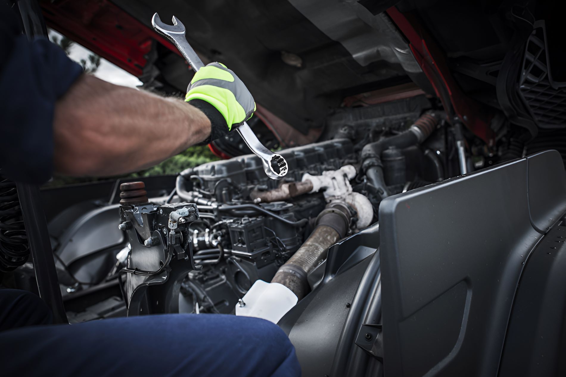A Man Is Working On A Truck Engine — All Models Service Centre In Port Macquarie, NSW