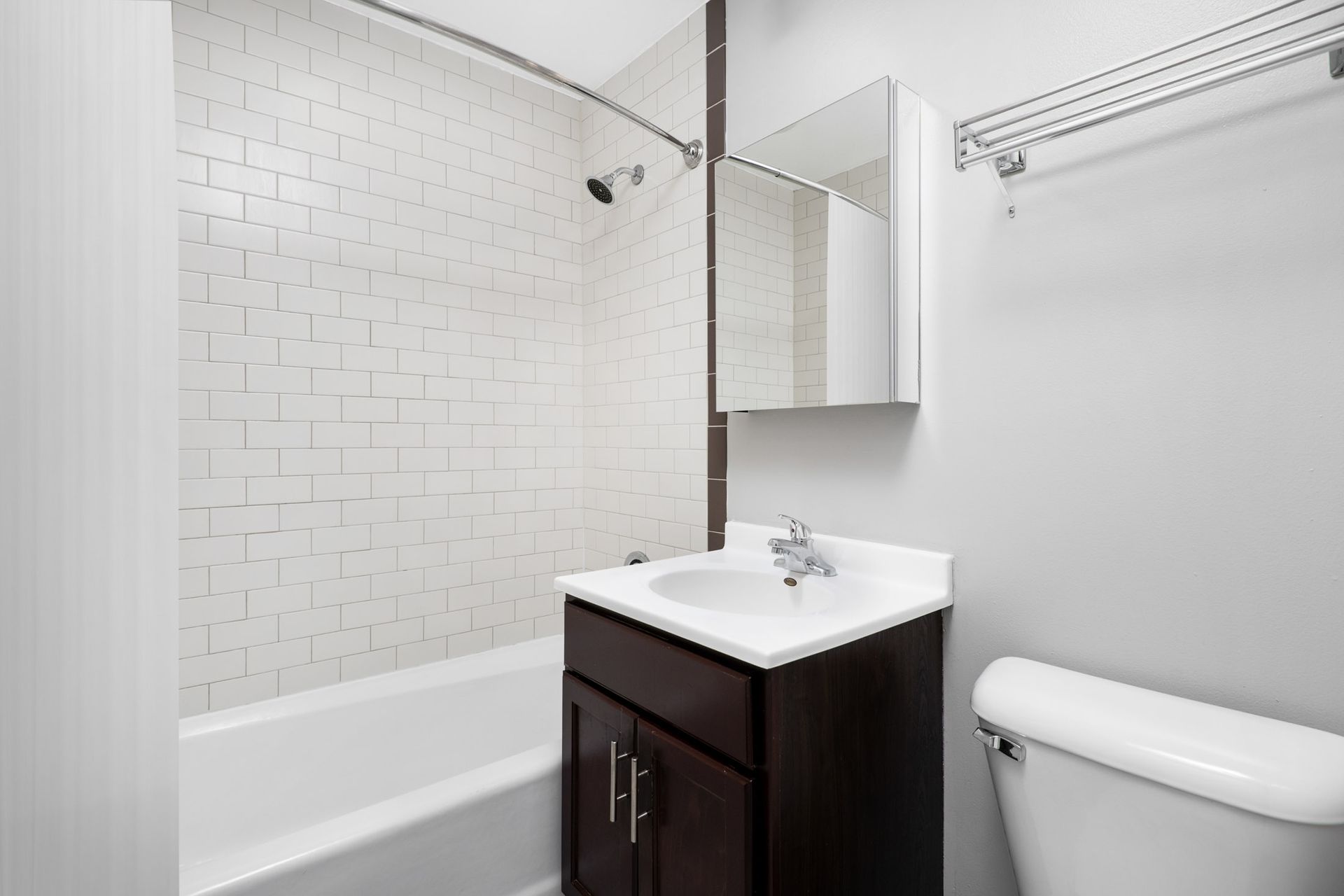 A bathroom with a sink, toilet, and bathtub at The Belmont by Reside.