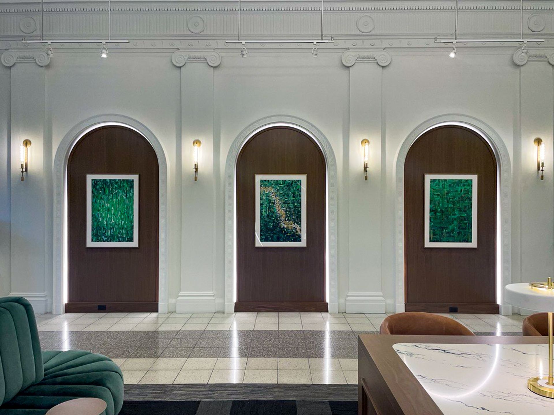 A living room with a green couch and a marble counter top.