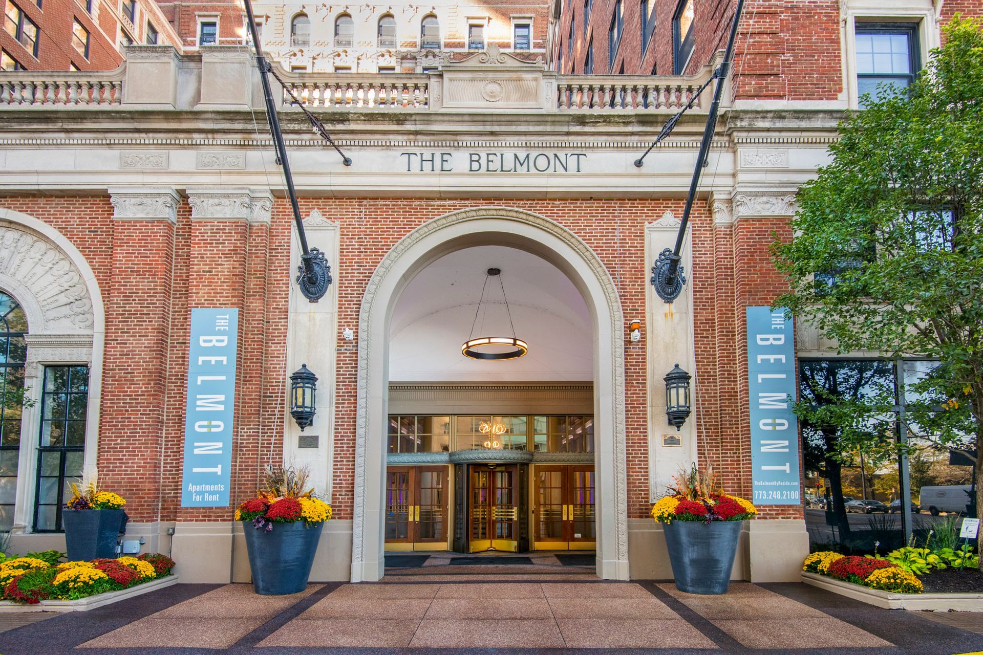 The entrance with flowers in front of it at The Belmont by Reside.