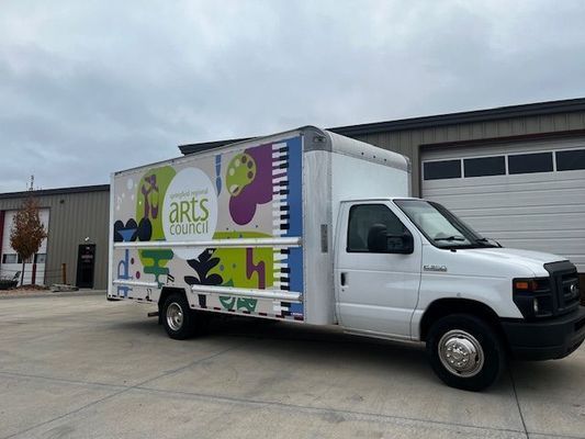 A White Truck With the Word Arts on the Side
