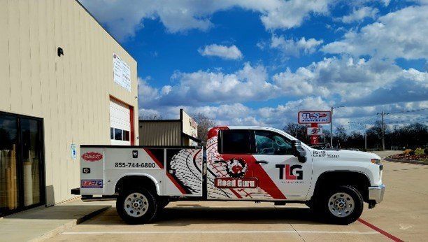 A White Truck is Parked in a Parking Lot in Front of a Building