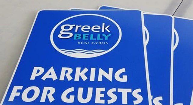 A Blue Sign That Says Parking for Guests on It