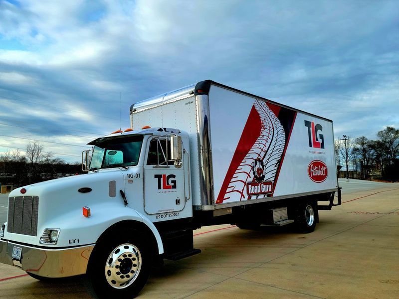 A white tg truck is parked in a parking lot