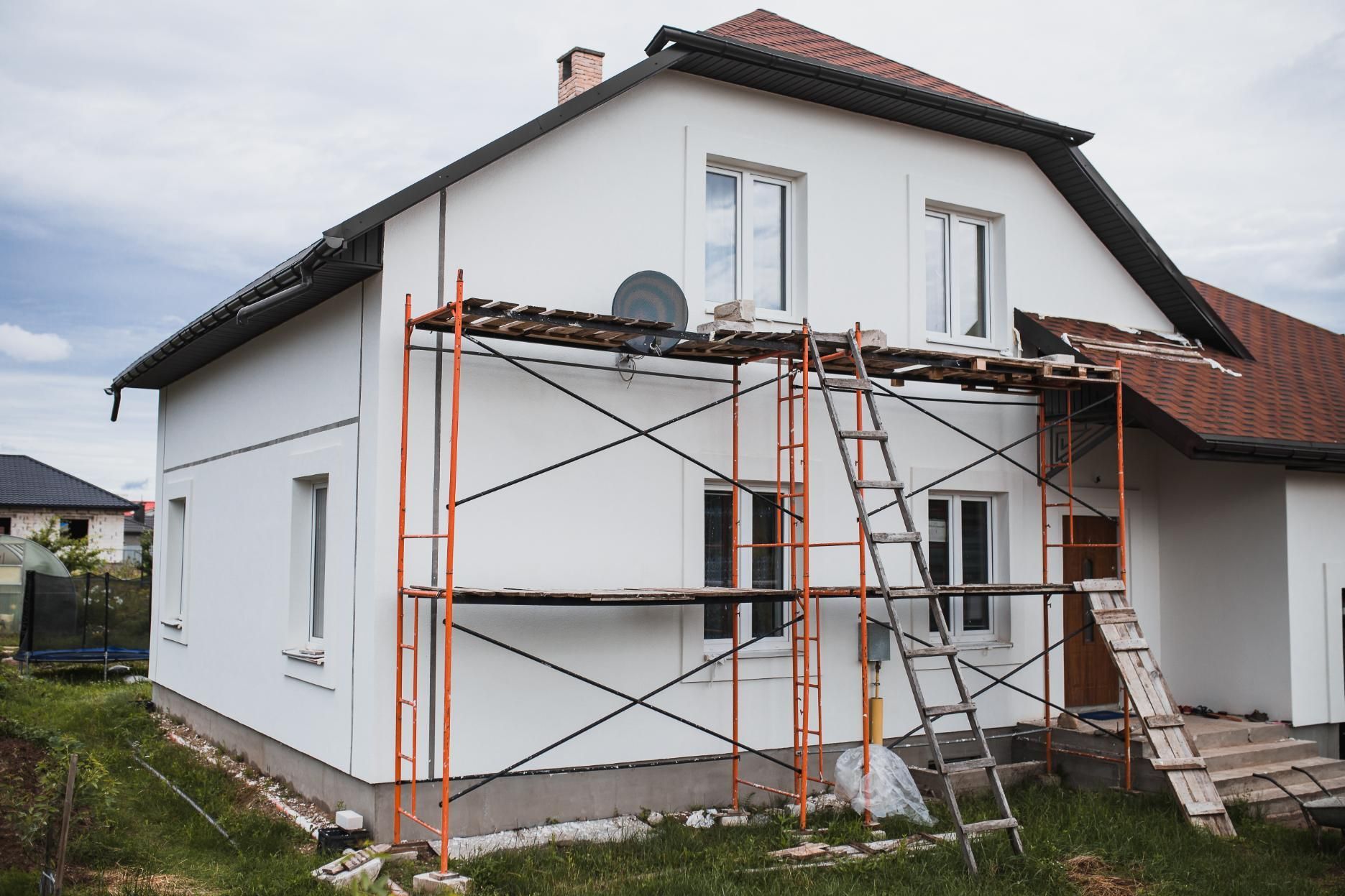 House exterior with orange scaffolding during renovation