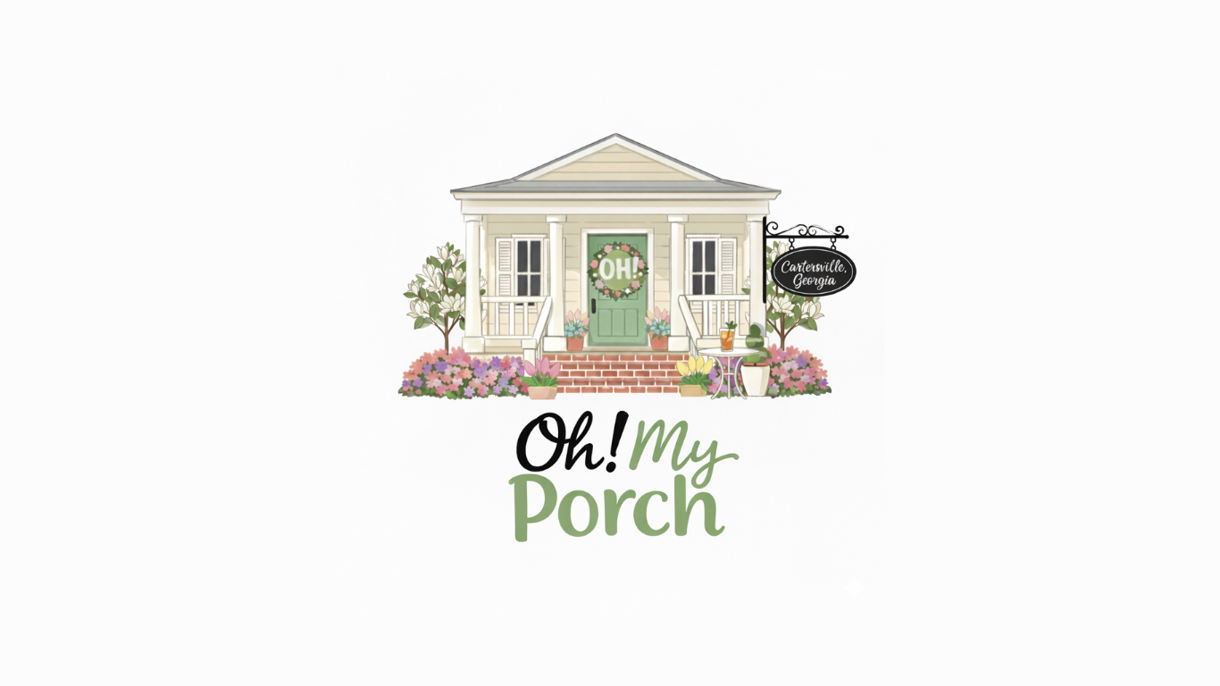 A logo featuring a light-colored house with a green door, surrounded by flowers, with the text