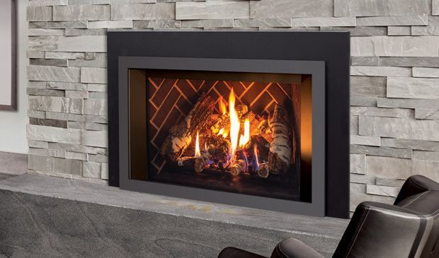 Modern fireplace with flames, set in a stone wall and dark gray frame. Modern fireplace with flames, set in a stone wall and dark gray frame.