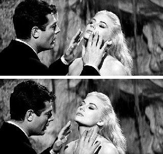 A man is touching the face of a woman in a black and white photo.