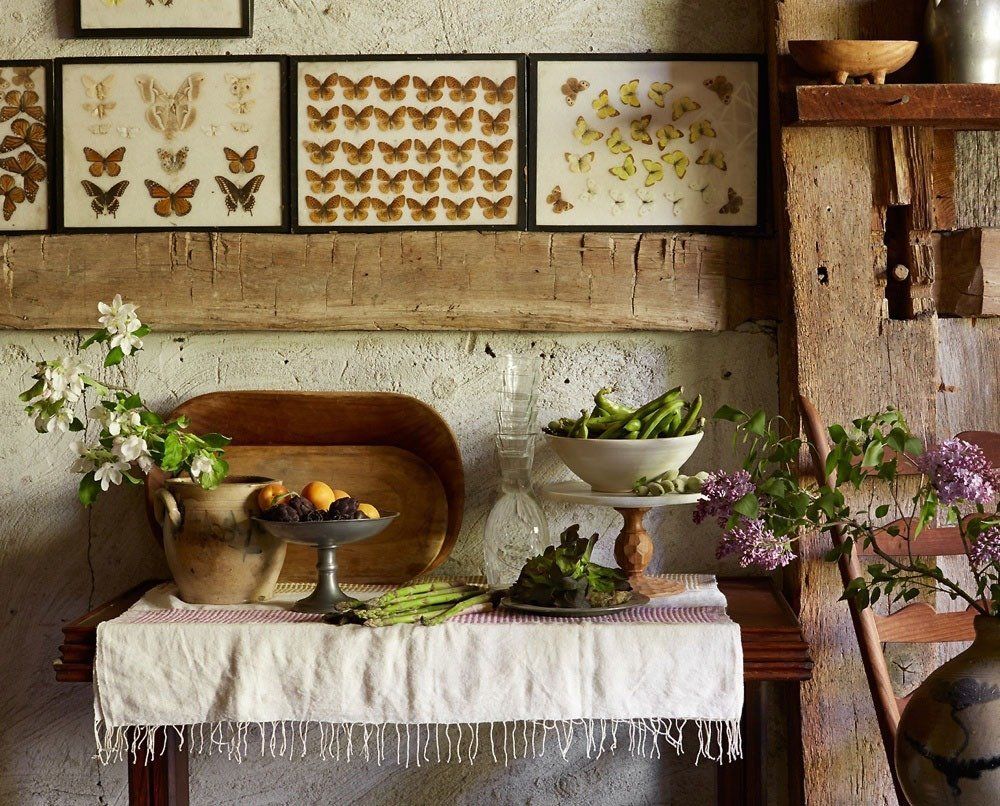 A table with a bowl of vegetables and flowers on it