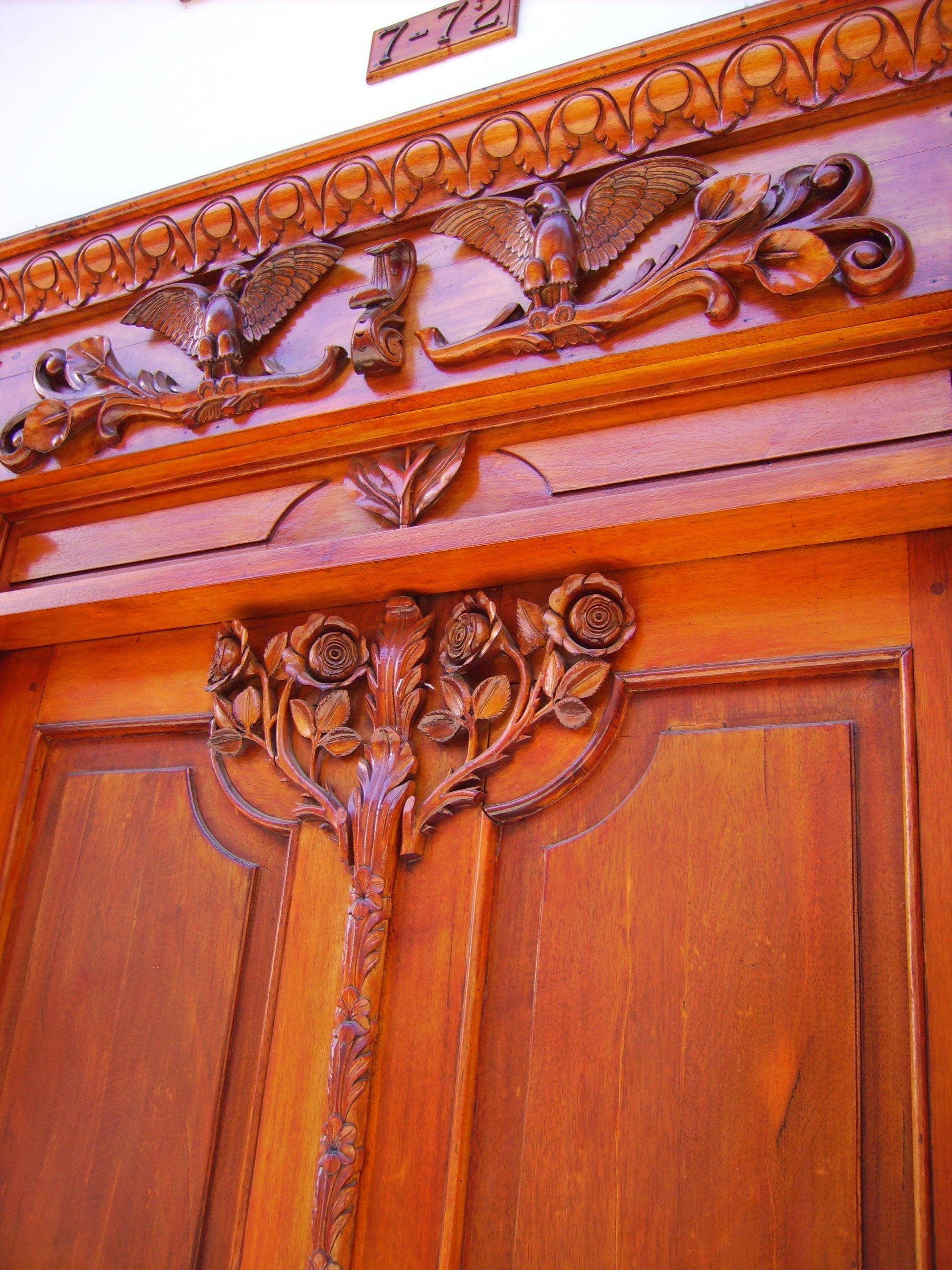 A wooden door with a carved design on it
