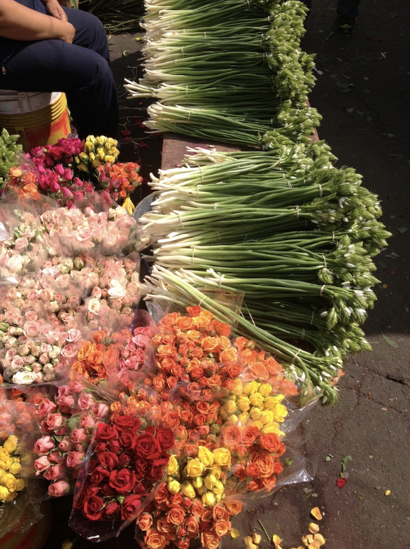 A bunch of different types of flowers are sitting on a table.