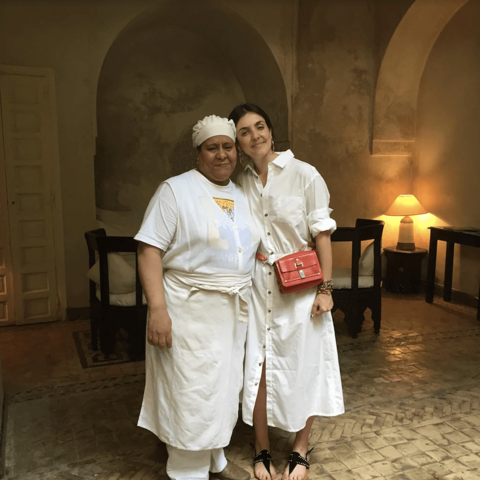 Two women standing next to each other in a room