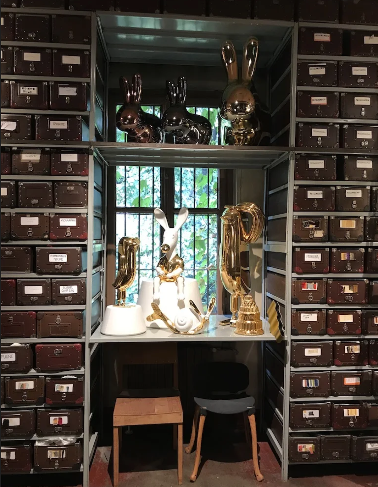 A room with lots of shelves and drawers and a desk