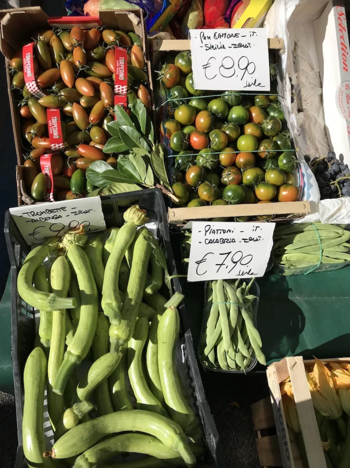 A variety of fruits and vegetables are for sale at a market.