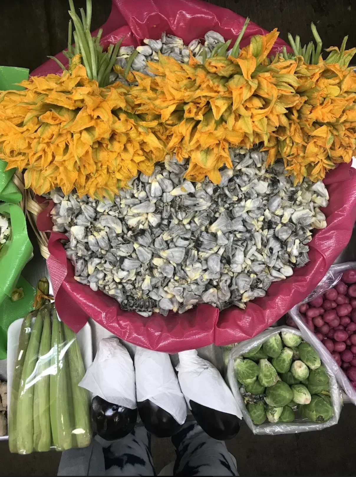 A bunch of flowers and vegetables on a table