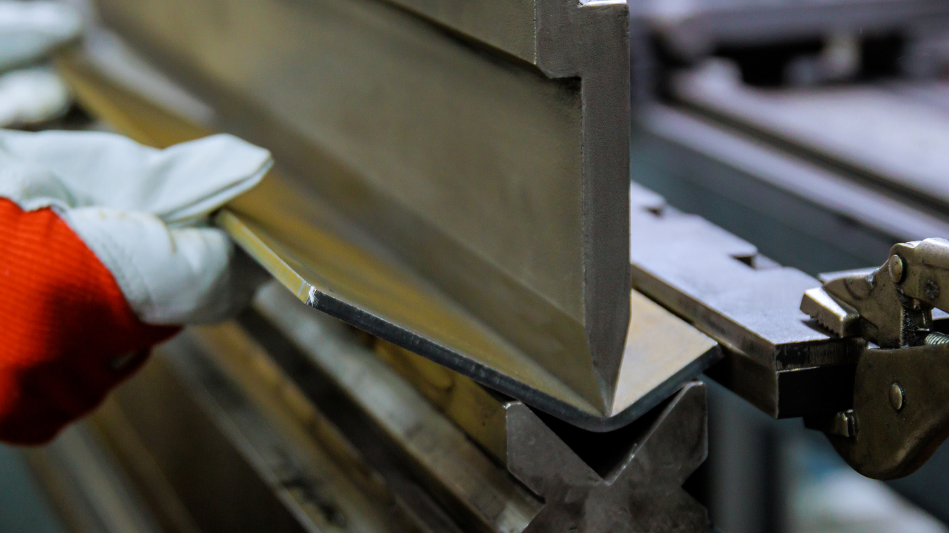 A close-up of a silver weld on a brushed metal surface.