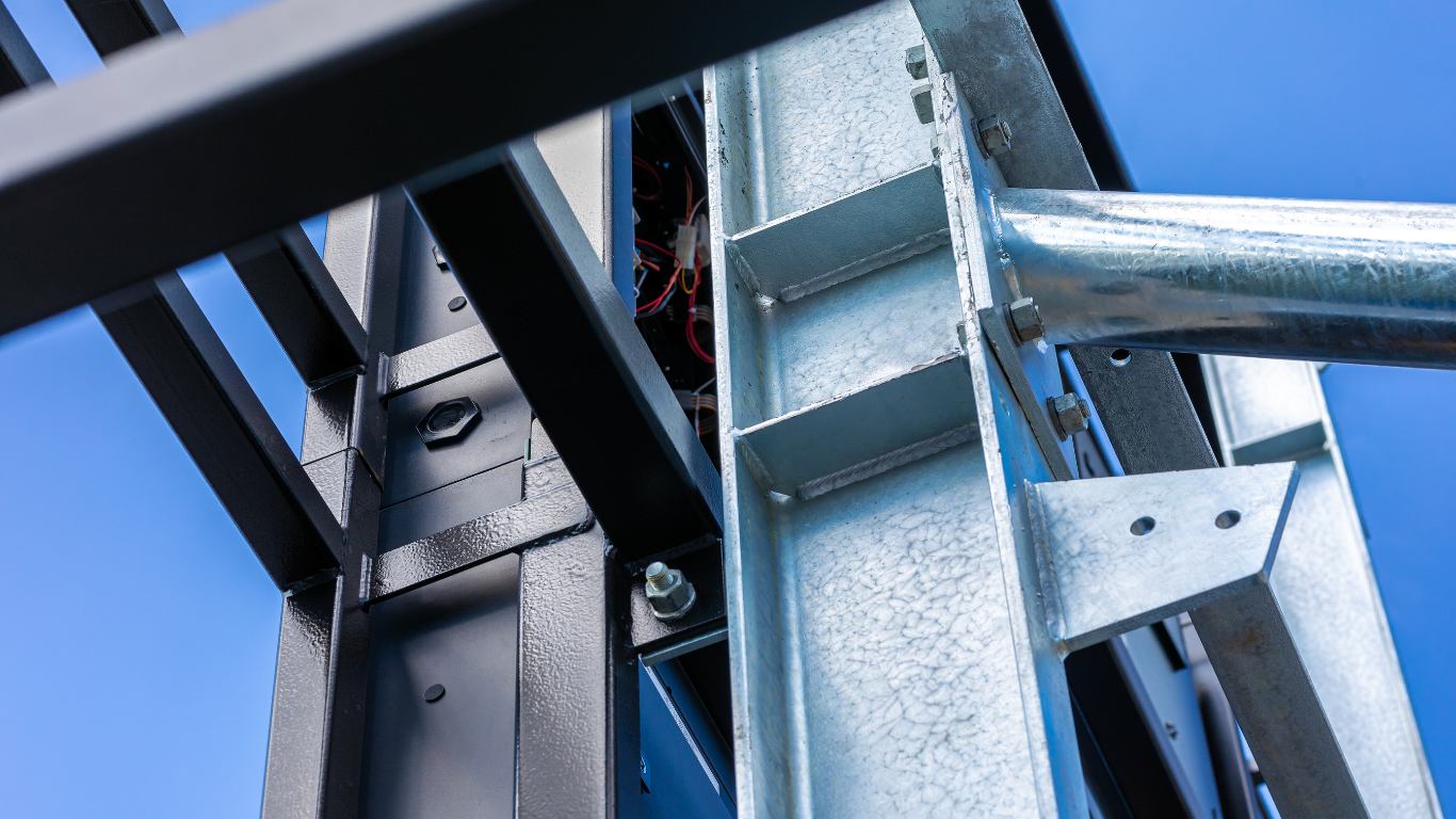 Steel I-beam on a construction site. Dark gray, metallic.