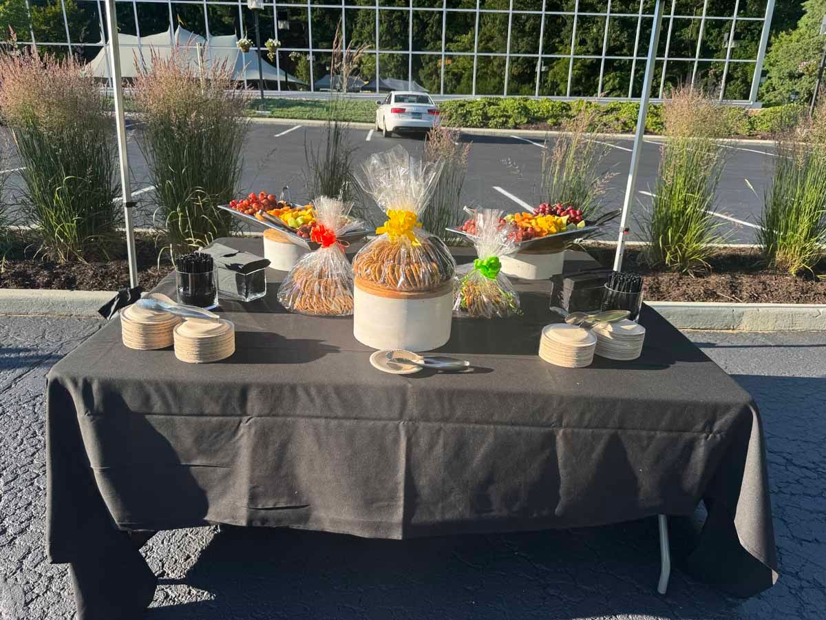 A table with a tablecloth and a bunch of food on it.