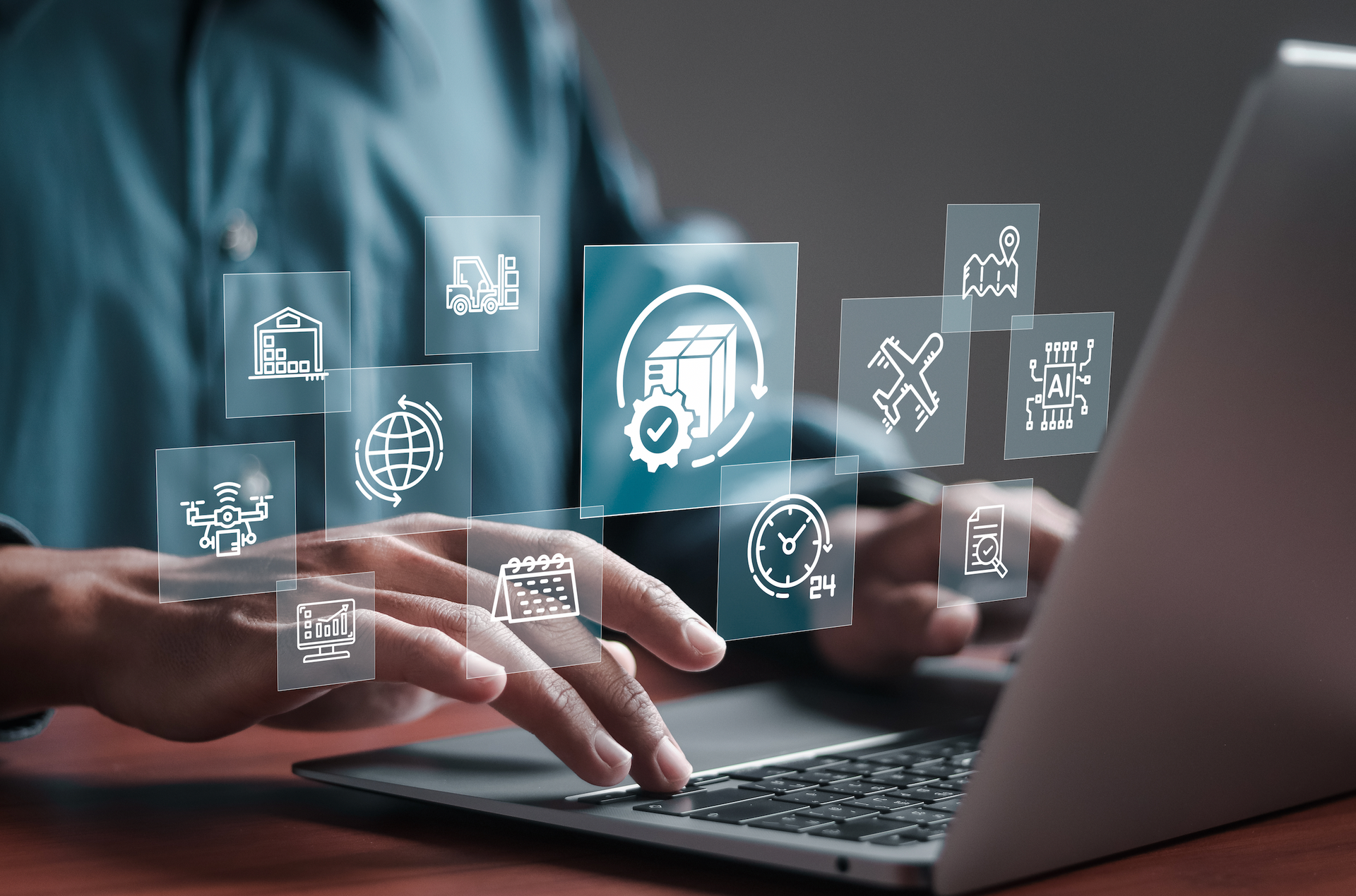Person using laptop with overlaid icons related to logistics and supply chain management.