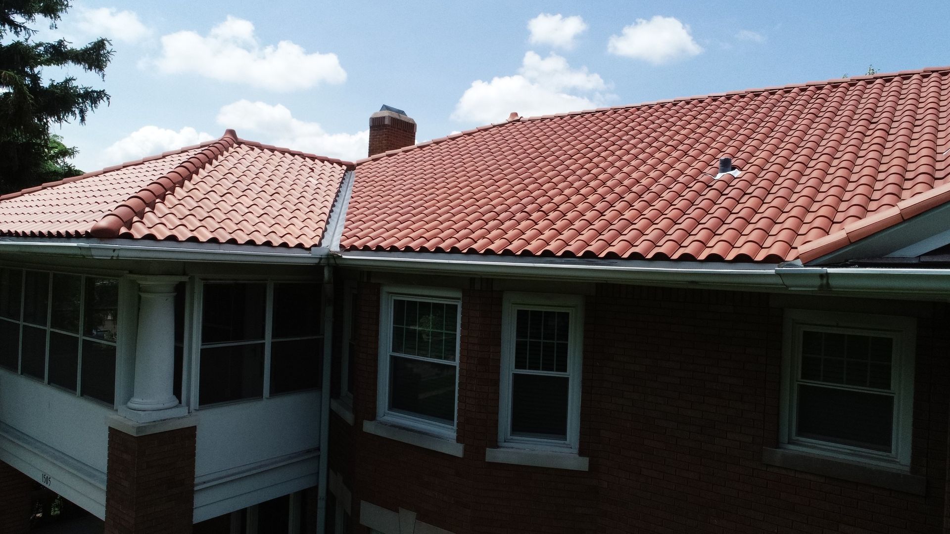 Elegant residential property showcasing a charming clay tile roof installed by Kreiling Roofing