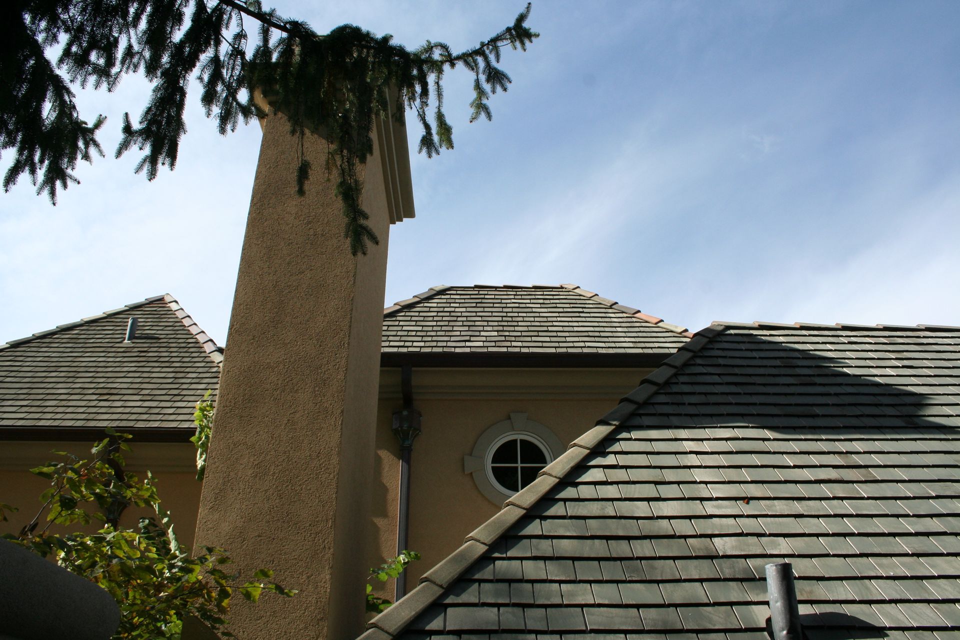 Harmonious blend of slate roofing and tile flashings, showcasing an elegant roofing masterpiece