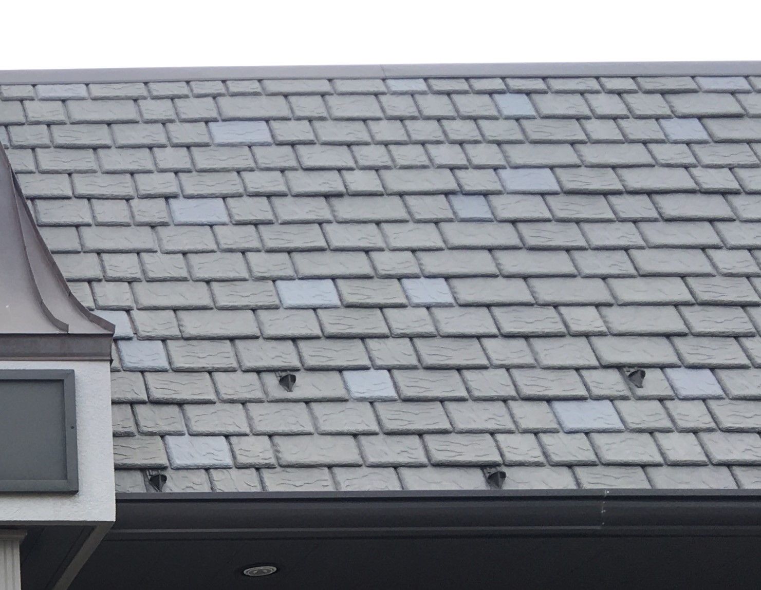 Mansard-style synthetic slate roof with installed snow guards for enhanced winter safety