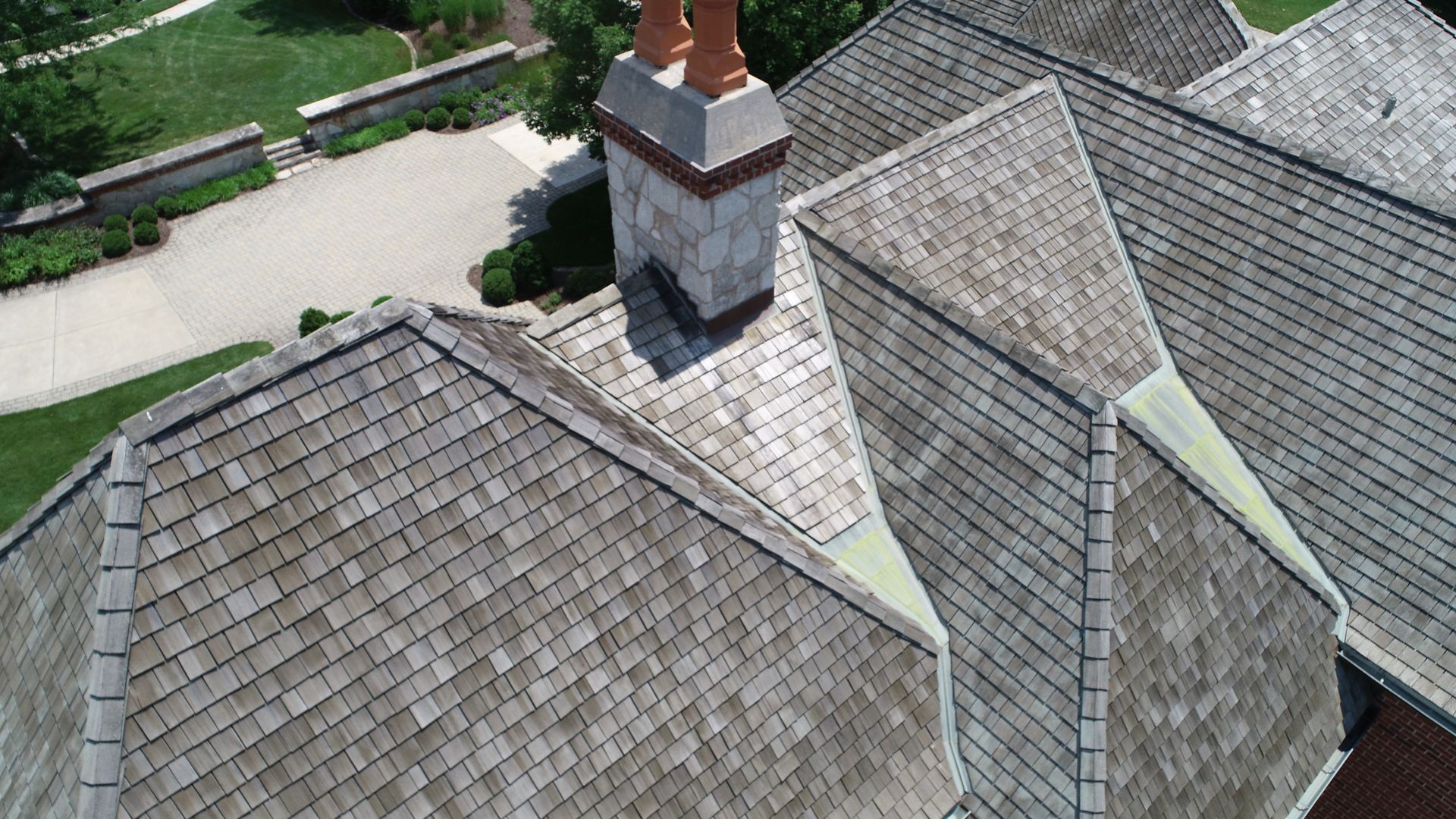 Aerial View of Wood Shake Shingles and Copper Saddles on a Charming Roof Design