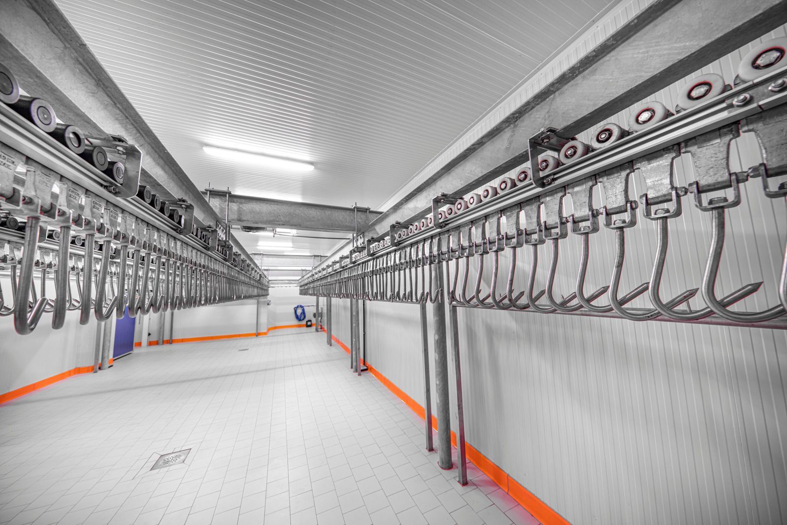 A large room with a lot of hooks hanging from the ceiling.