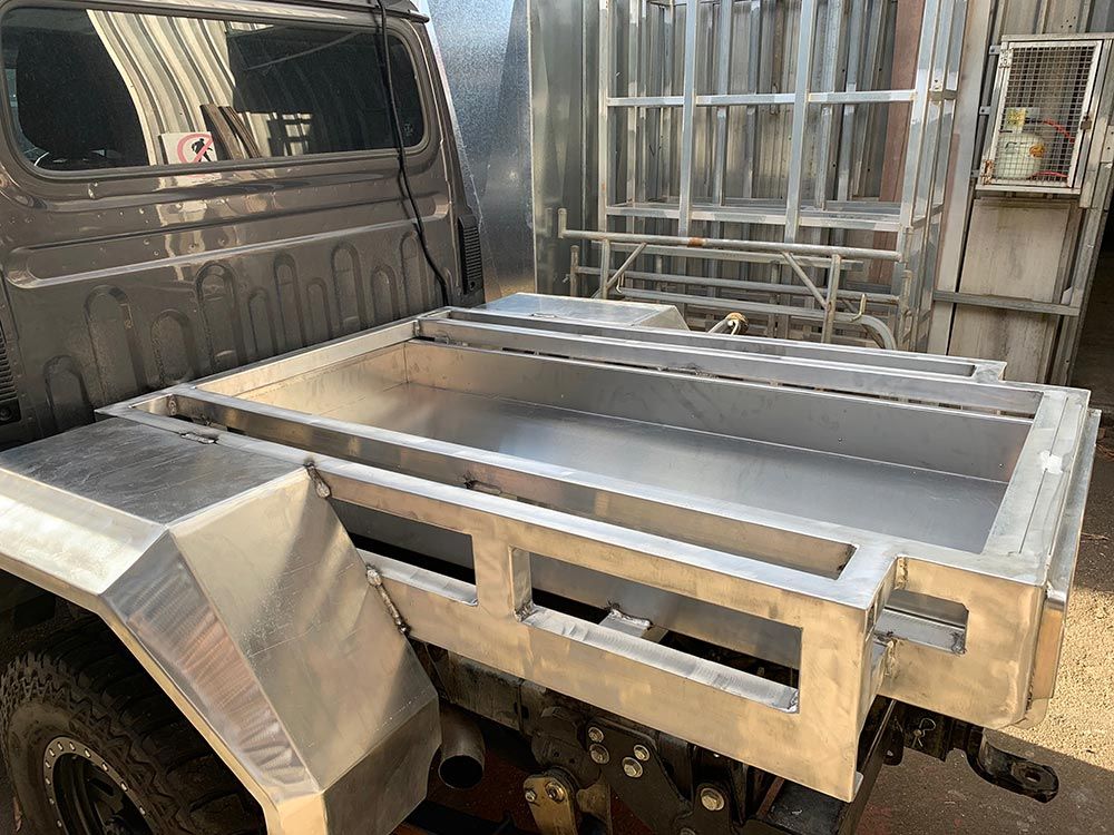 A Truck With a Stainless Steel Tray on the Back of It — Clarry Anderson Sheet Metal Pty Ltd in Port Macquarie, NSW
