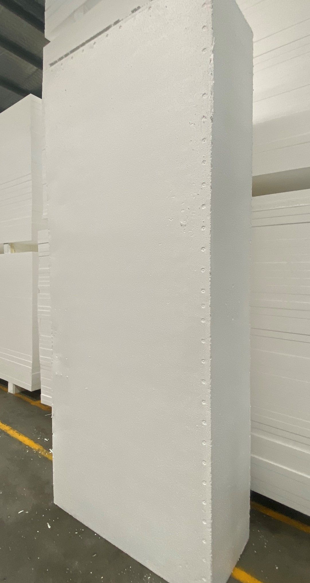 A stack of white styrofoam blocks in a warehouse.